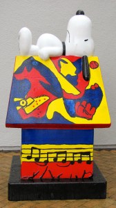 Snoopy on top of his doghouse.